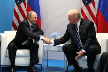 Russian President Vladimir Putin and U.S. President Donald Trump shake hands during their bilateral meeting on the sidelines at the G20 Summit in July 2017 in Hamburg, Germany. (Kremlin Pool)