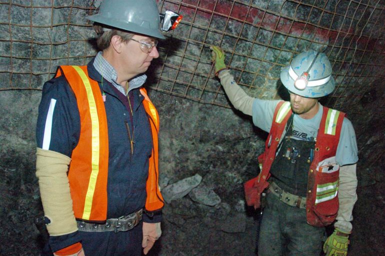 Former Stillwater Mining Company CEO Mick McMullen, left, talks about the company’s mine near Nye, Montana with geologist Robbie McMahon during a visit to the underground operation in 2015. (AP Photo, Matt Brown)