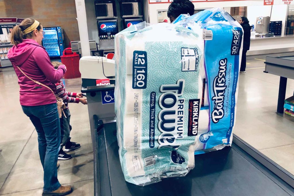 A shopper pays for packages of toilet paper and hand towels at a Costco warehouse as fear of the coronavirus spreading continues in Lone Tree, Colo. (AP Photo, David Zalubowski)