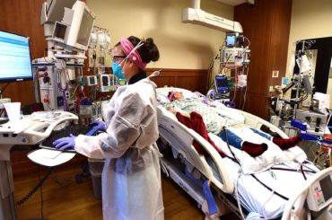 Katie Kukowski cares for a patient in the intensive care unit at Billings Clinic during the COVID-19 pandemic. (AP Photo, Larry Mayer)