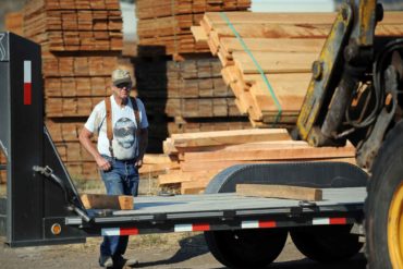 Bill Calovis watches as lumber is loaded onto his truck at the B&J Sawmill in Reed Point. (AP Photo, James Woodcock)