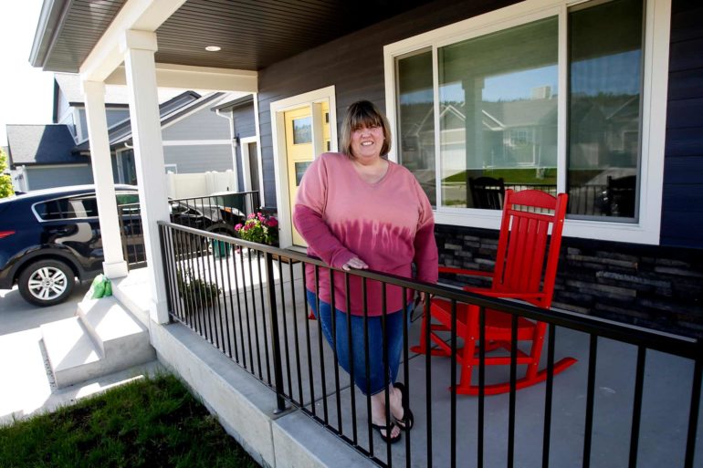 Melisia Muscat stands on the front porch of her new home in Billings that she and her husband bought sight unseen before moving from the Seattle area. (Casey Page, Billings Gazette)