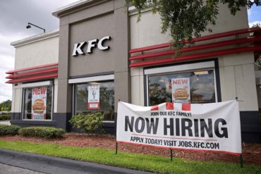 A now hiring sign advertises job openings outside a Kentucky Fried Chicken restaurant. (Phelan Ebenhack, AP Photo)